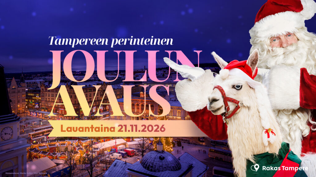 Joulupukki osoittaa Joulun avaus-tekstiä, jonka taustalla näkyy jouluisesti koristeltu ja valaistu Keskustori.